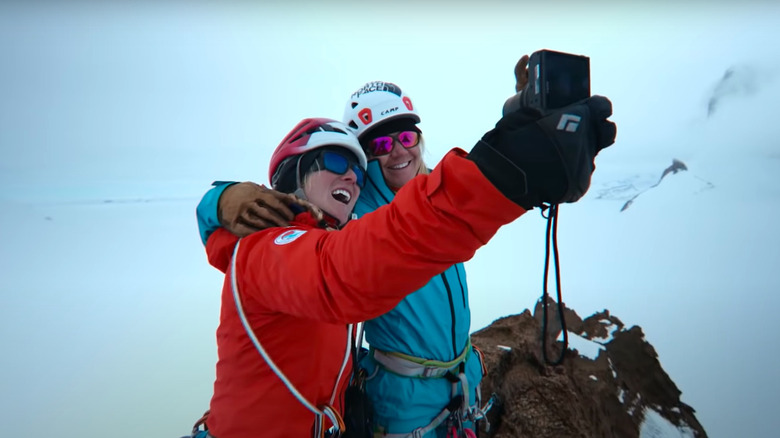 Athletes in The North Face taking selfie on mountain