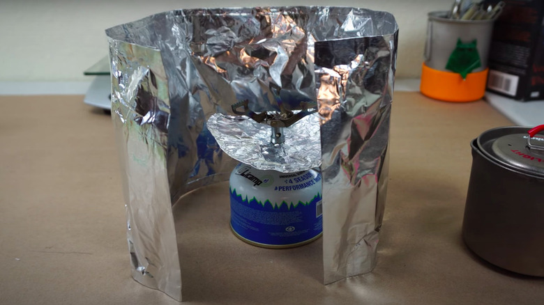 wall of aluminum foil around flame
