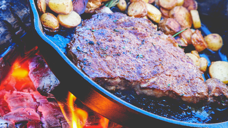 Steak and potatoes on campfire 