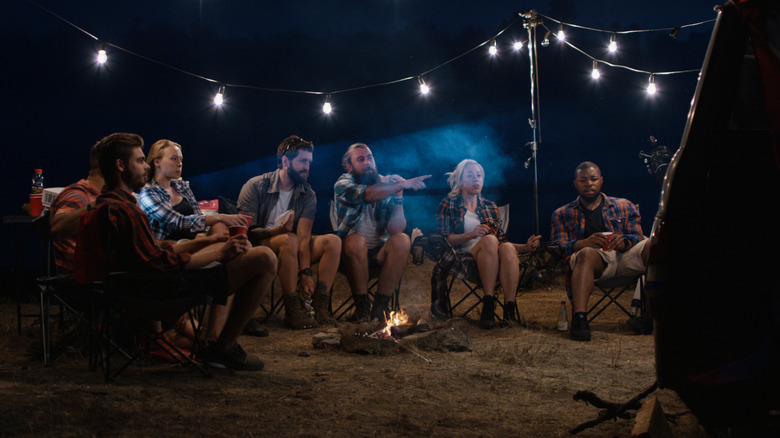 Campers watching movie on screen