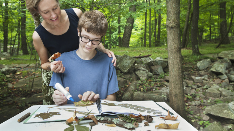 Mother and son making art with natural elements