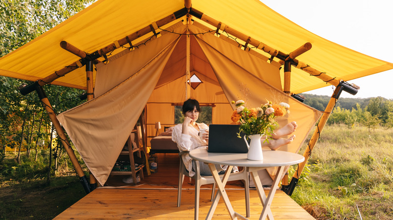 Woman sitting outside of aesthetically pleasing tent with decor