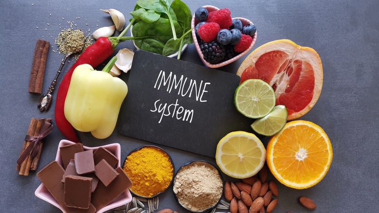 Fruits and vegetables surrounding a sign that reads "immune system"