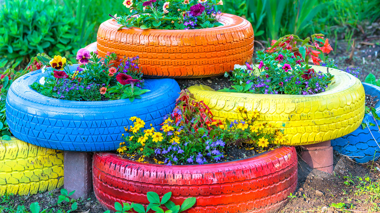 Colorful tire planters in garden