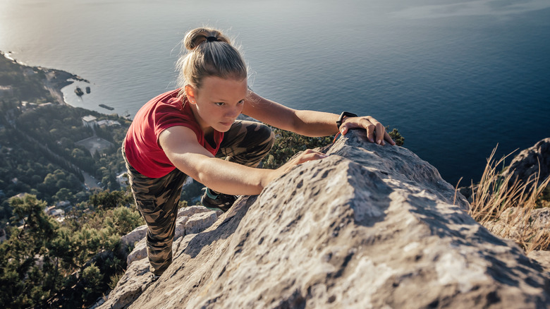 Girl climbing a mountainside 