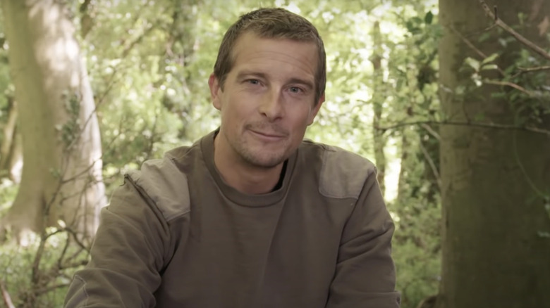 Bear Grylls with a forest in the background