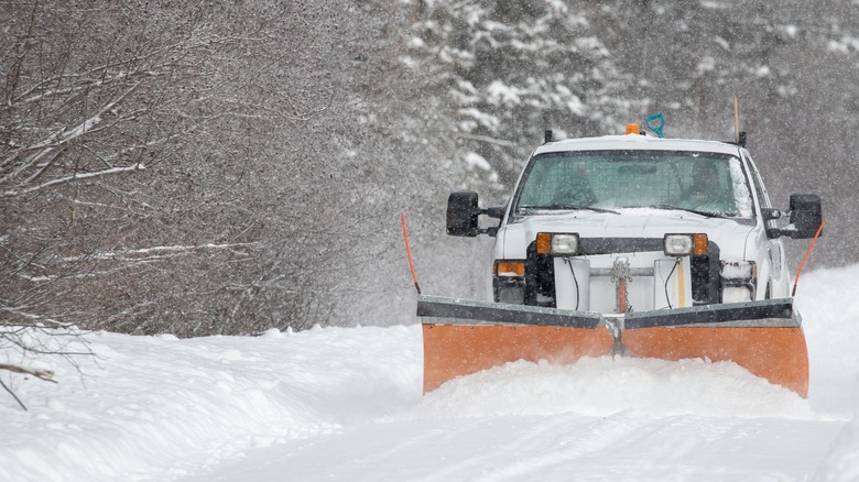 Plow truck driving in snow