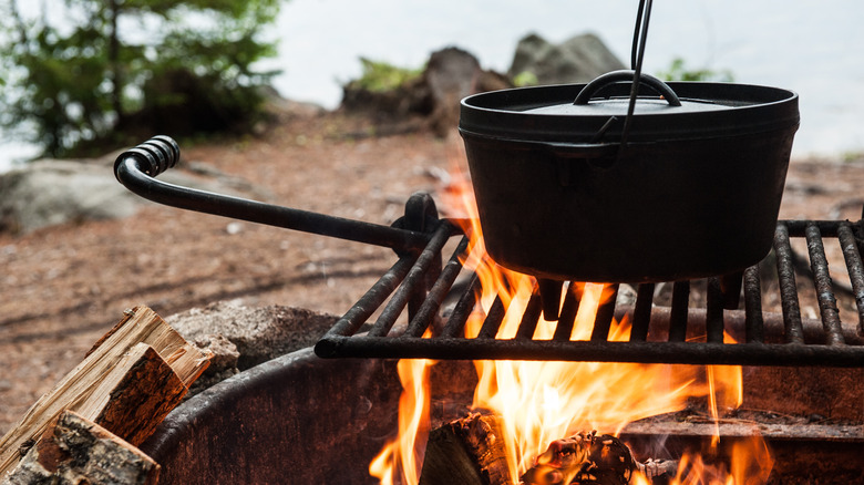 Cast irons cooking over a campfire