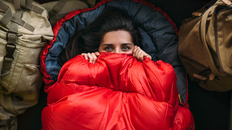 Person in red sleeping bag