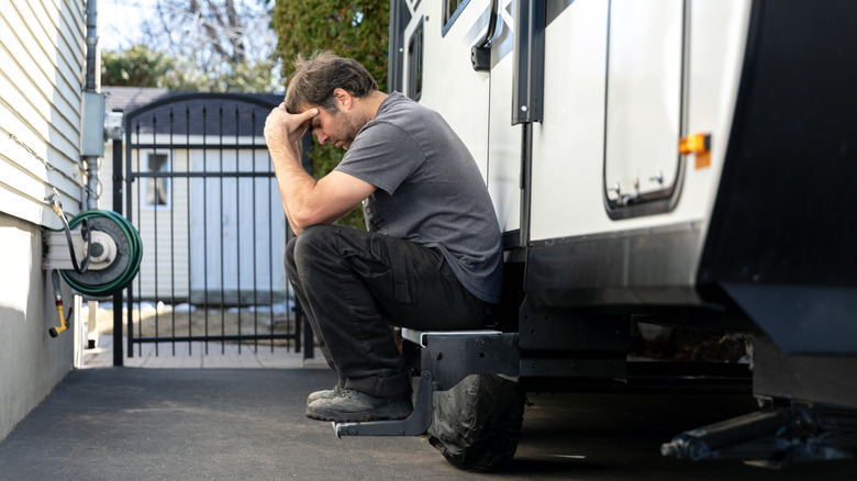 Upset man sitting outside RV