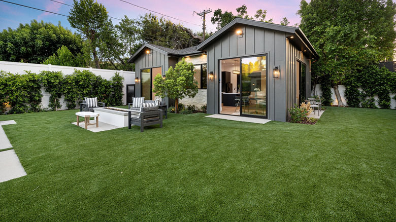 small house with lush green lawn