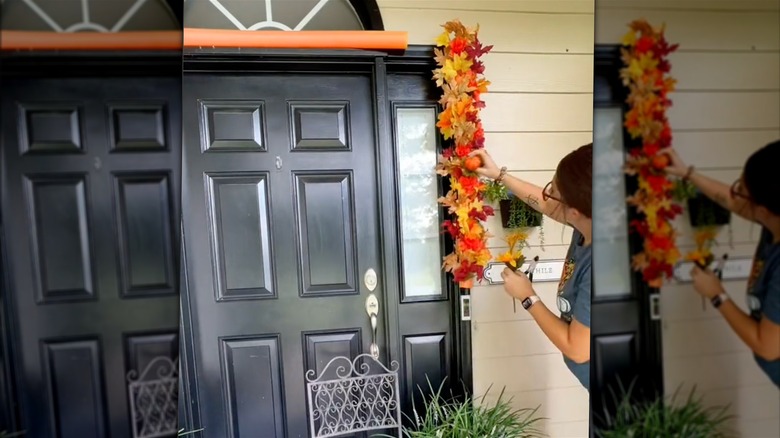 Person piercing fall leaves into orange foam noodle