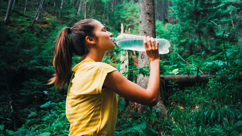 hiker drinking water from bottle