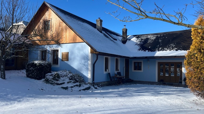 A house with a snowy driveway and walkway