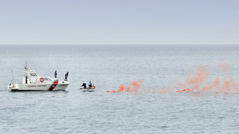 boaters being rescued after smoke signal deployed