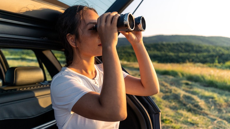 Woman looking through binoculars