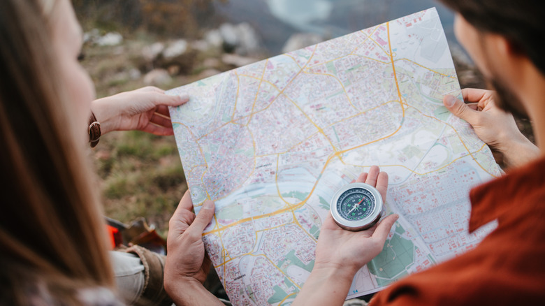 Couple looking at map and compass