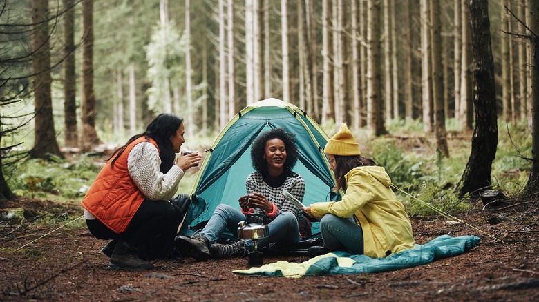 Three happy women at campsite