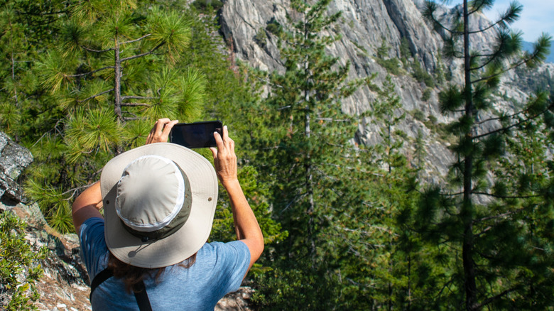 Woman taking a photo at Castle Crags State Park