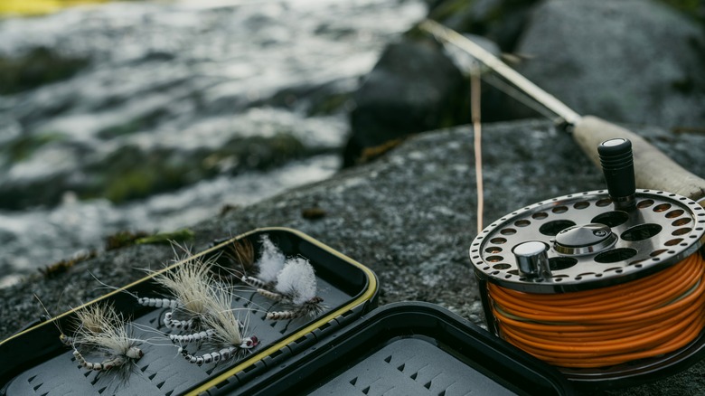 fly fishing equipment near stream