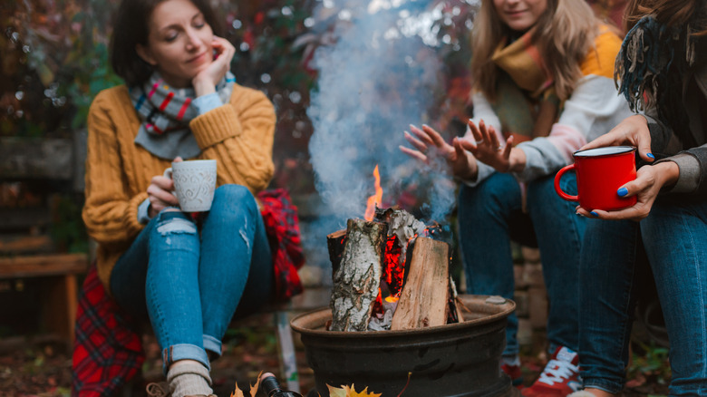 Women around a campfire in fall