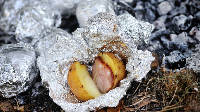 Baked potato and ham wrapped in foil