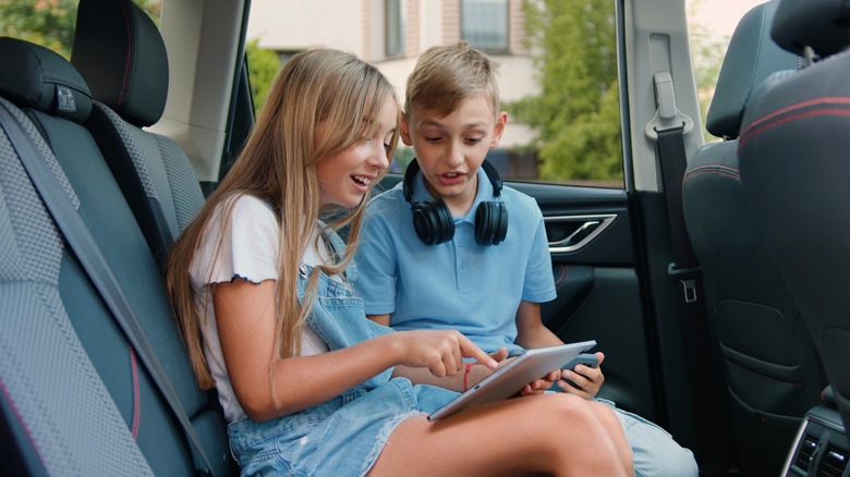 Kids enjoying games in the car