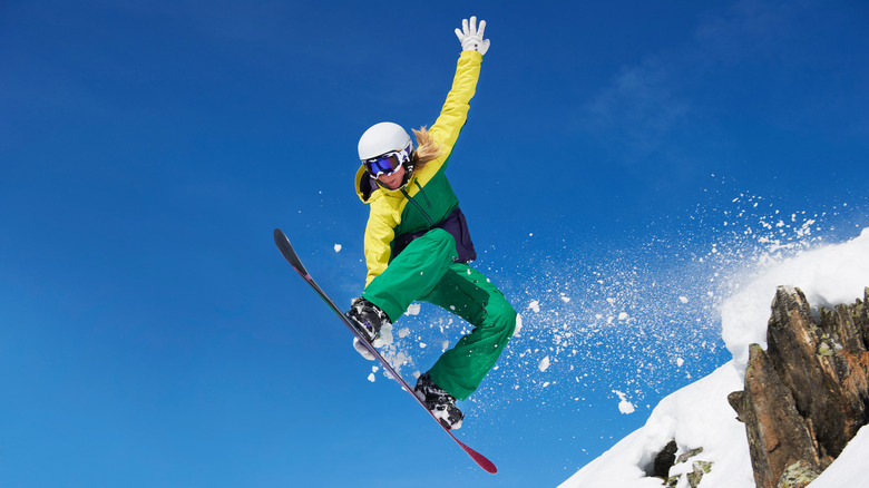 Person doing a jump on a snowboard