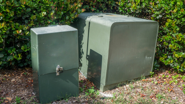 green utility boxes in yard