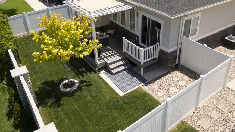 Aerial view of home with privacy fence around garden