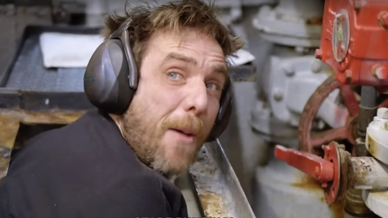 Man fixing a leak on a boat