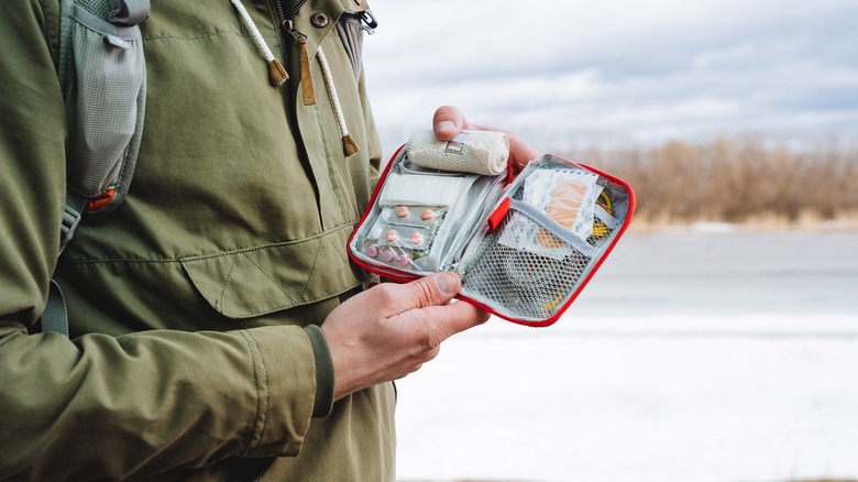 Hiker holding first aid kit