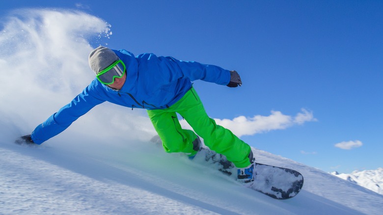 Man snowboarding down hill