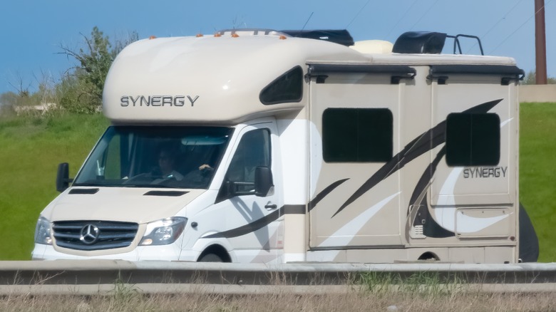 RV with slide toppers driving