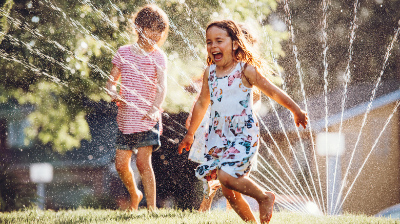 Kids playing in sprinkler