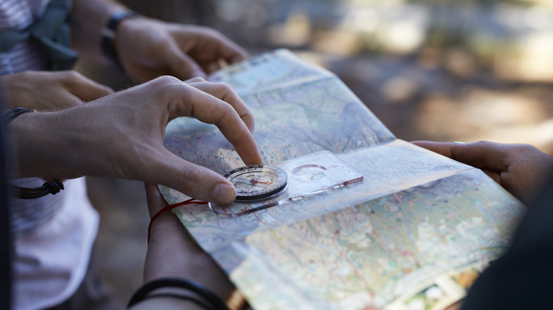 Person using compass and map