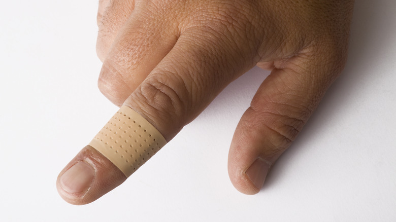 Pointer finger with adhesive bandage