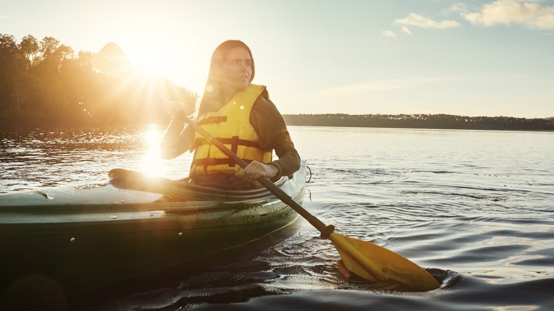 woman kayaking on lake