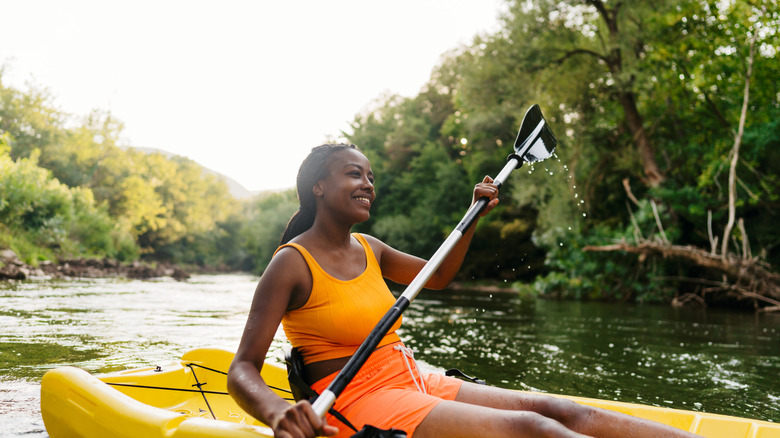 woman kayaking on river