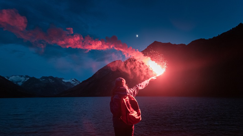 Boater using handheld flare at night