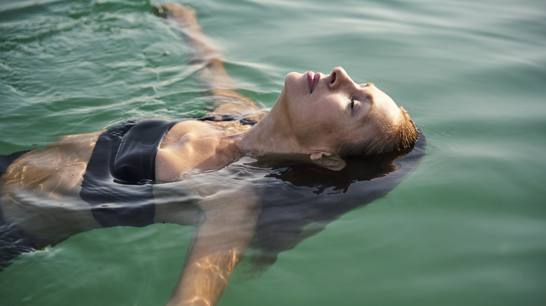 woman floating on back in ocean