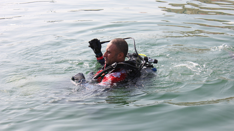 scuba diver floating on surface