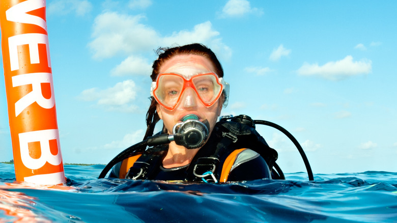 diver on surface with a marker buoy