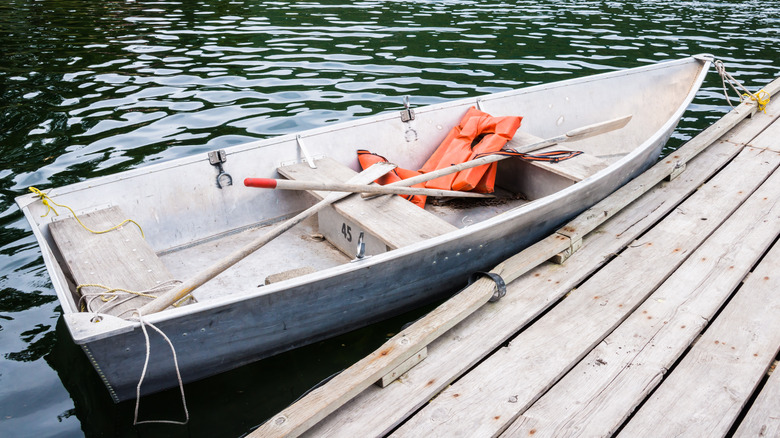 boat with paddles and lifejackets at dock