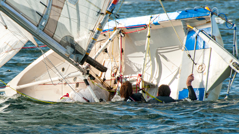 sailors with capsized boat