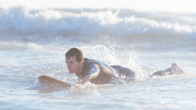Surfer paddling to shore