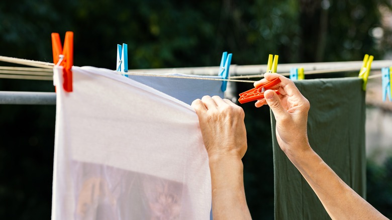 Clipping clothes on a clothesline outside