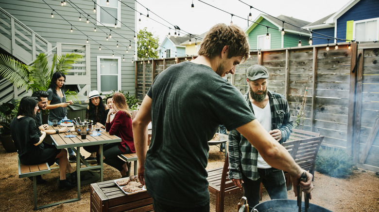 Group of friends grilling outside