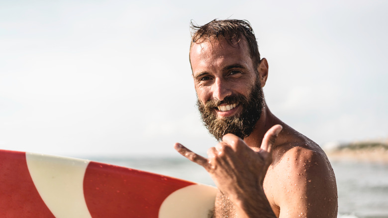Male surfer smiling at camera