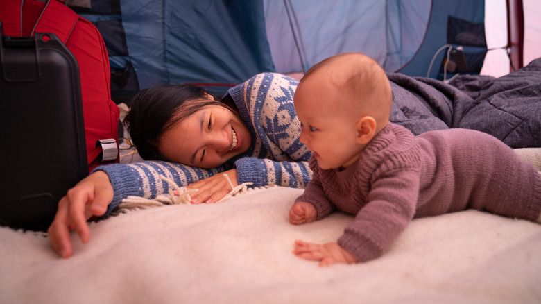 mom and baby in a tent